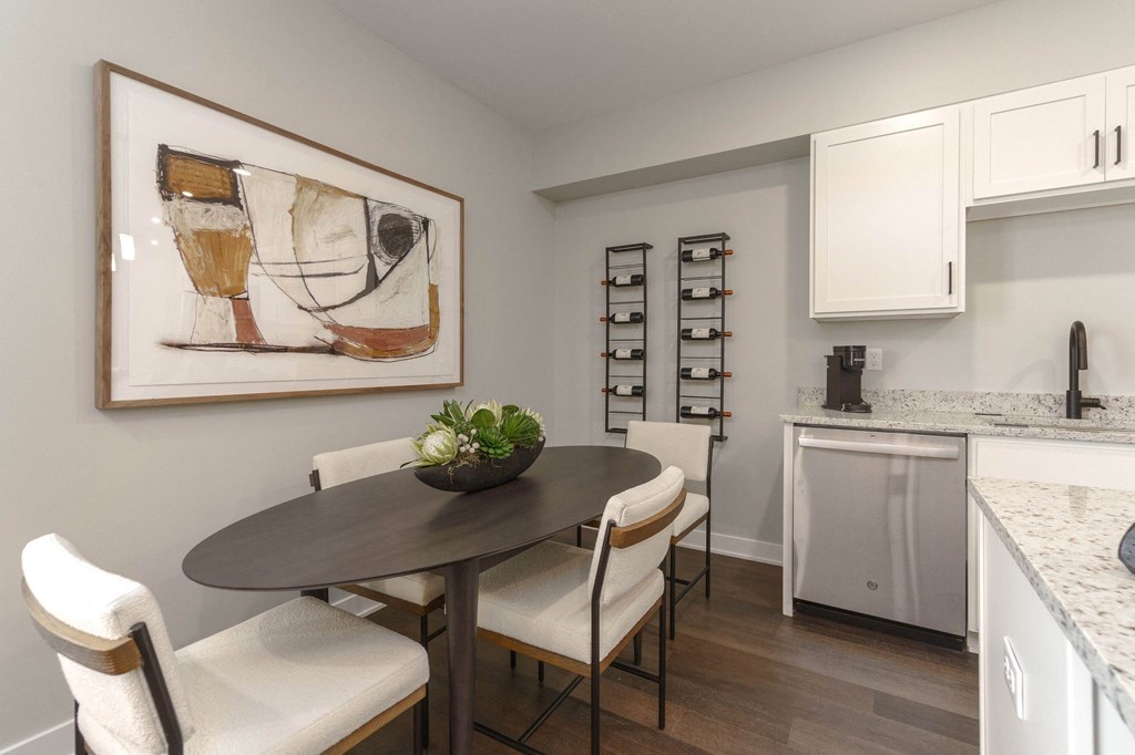 a kitchen and dining room with a table and chairs